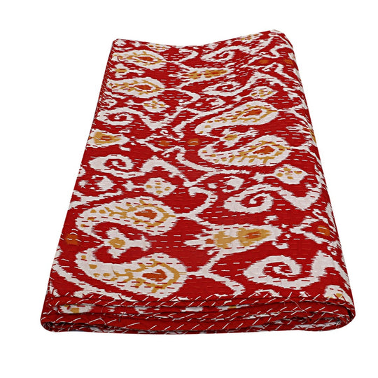 Folded red ikat design Kantha blanket with hand-stitched details and lightweight cotton voile fabric
