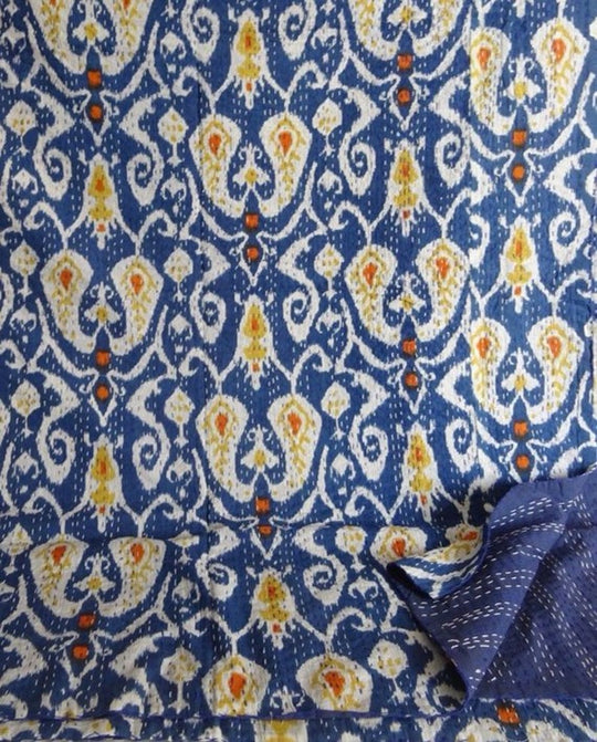 Blue and white Ikat design Kantha blanket with hand-stitched quilting and colorful detailing