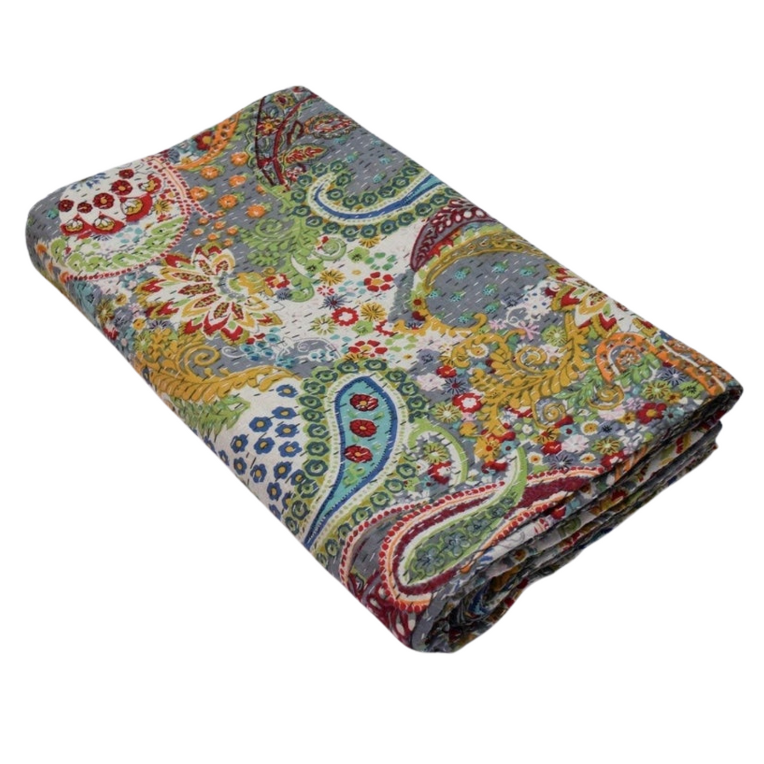 Folded colorful paisley pattern Kantha Blanket made of 100% cotton voile with hand-stitched quilting and reversible solid backing.