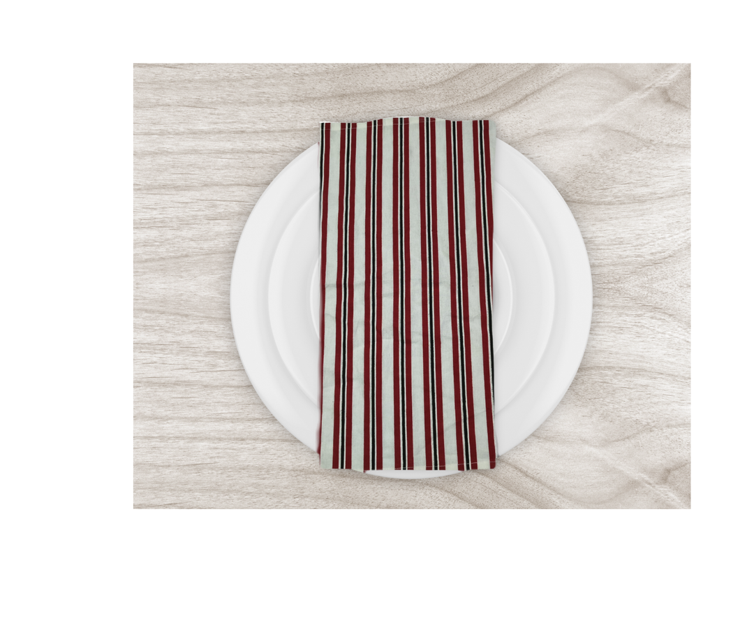 Cotton table linen striped napkin on white plate over wooden table surface